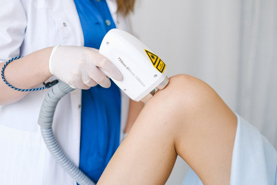 a medical esthetician performing laser therapy